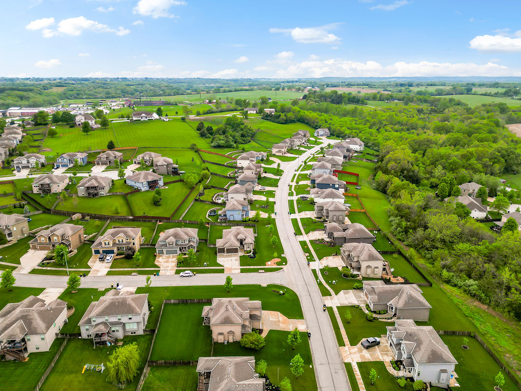 Rock Creek subdivision Lansing Kansas aerial — newer homes near Fort Leavenworth with open green space, popular with military families PCS'ing to the area