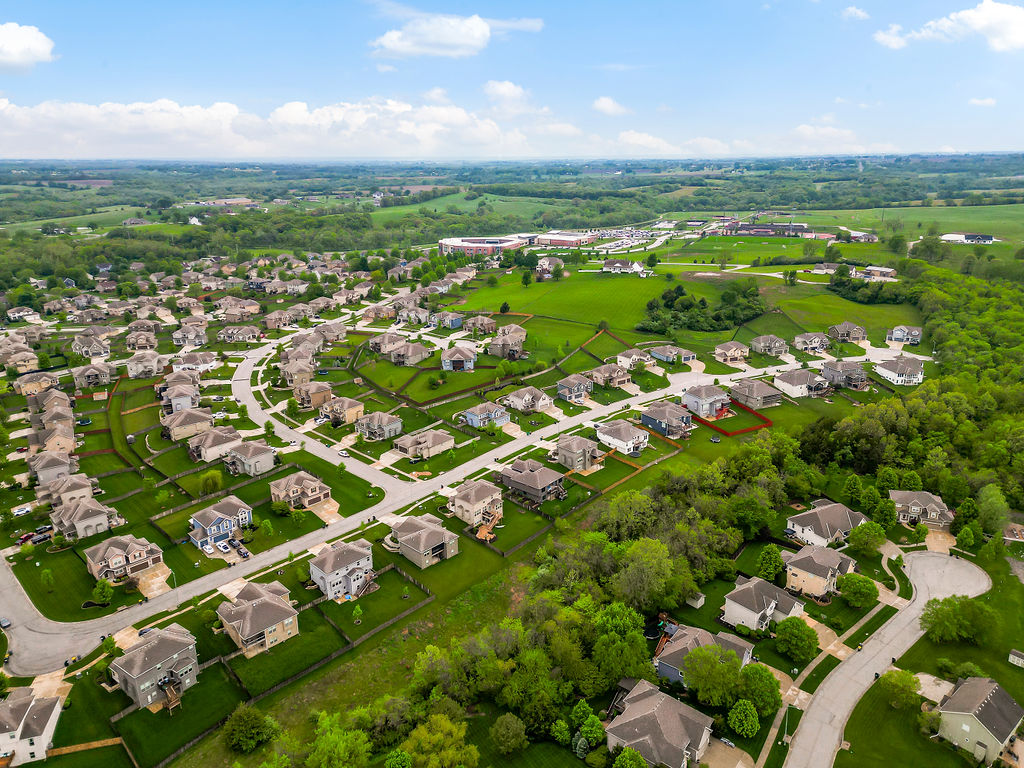 Rock Creek subdivision Lansing Kansas aerial — newer homes near Fort Leavenworth with open green space, popular with military families PCS'ing to the area