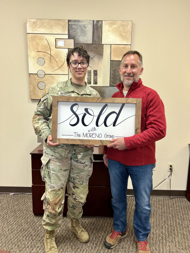 Real estate agent Jim Moreno shaking hands with a veteran homebuyer after closing on a home in Leavenworth, Kansas. The Moreno Group Real Estate Professionals specializes in VA loans and PCS relocation for military families near Fort Leavenworth.