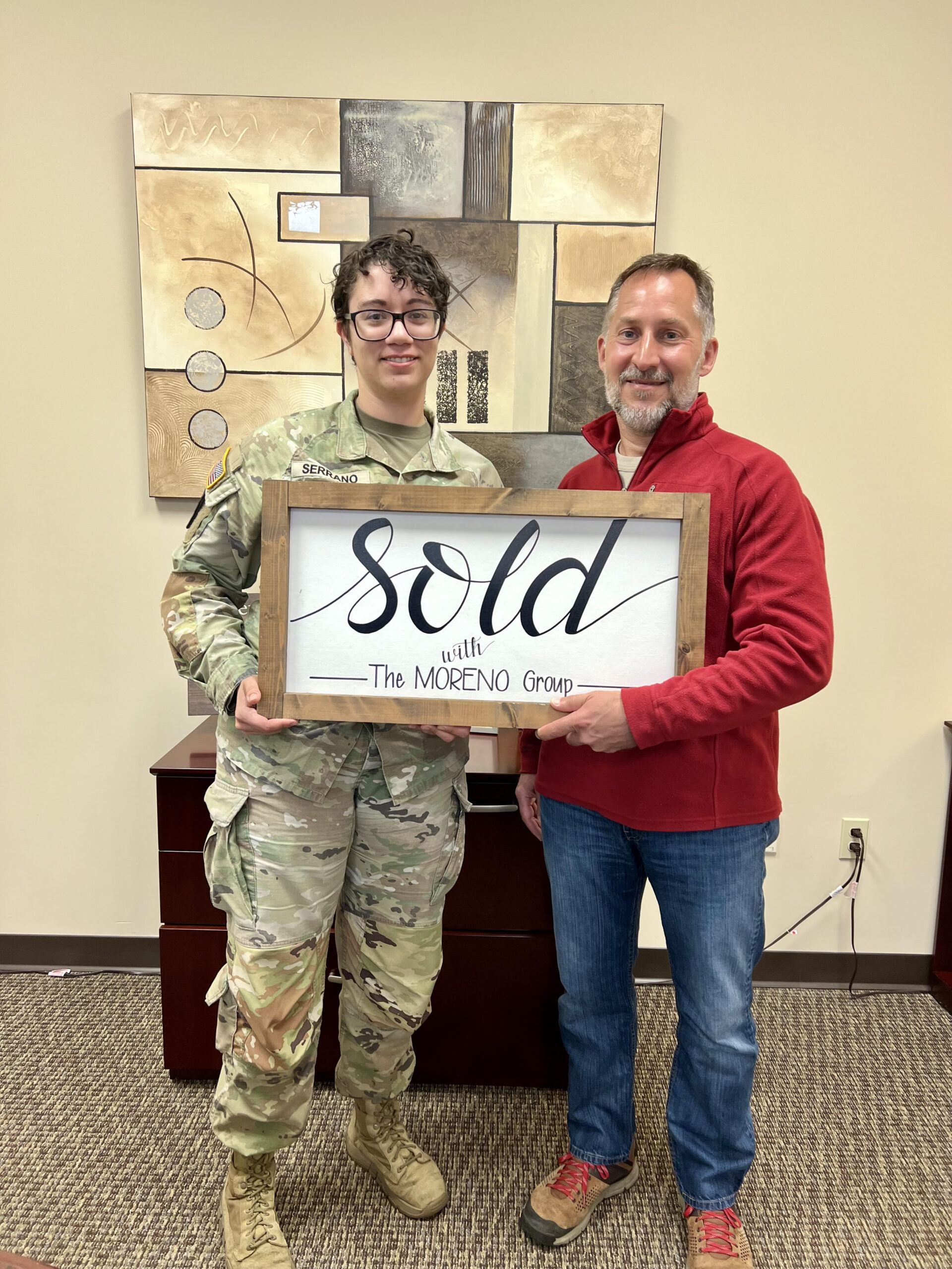 Real estate agent Jim Moreno shaking hands with a veteran homebuyer after closing on a home in Leavenworth, Kansas. The Moreno Group Real Estate Professionals specializes in VA loans and PCS relocation for military families near Fort Leavenworth.